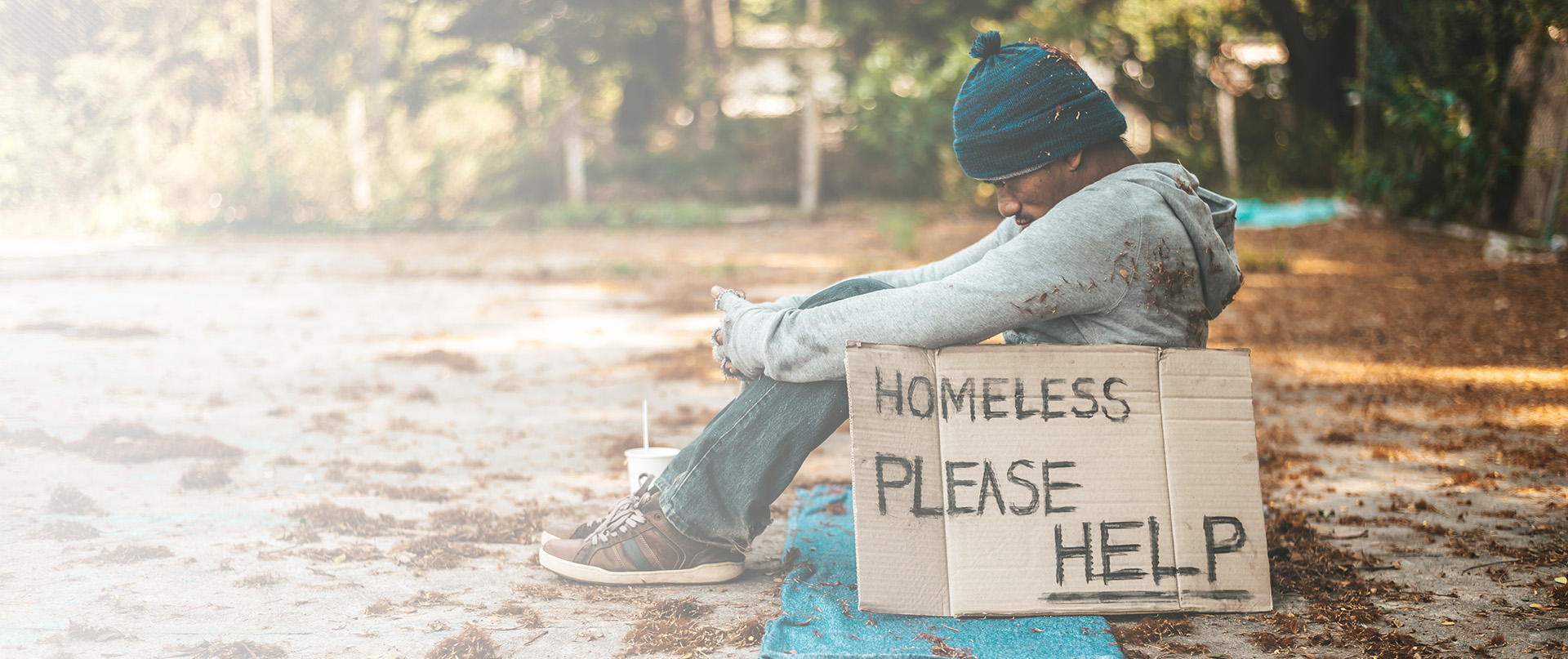 Beggars sitting on the street with homeless messages please help